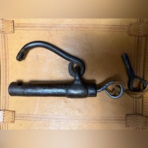 antique iron padlock with a screw key system and a separate key.